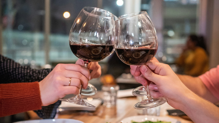 Group of people cheers with wine